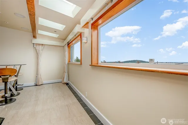 a view of workspace with wooden floor and windows