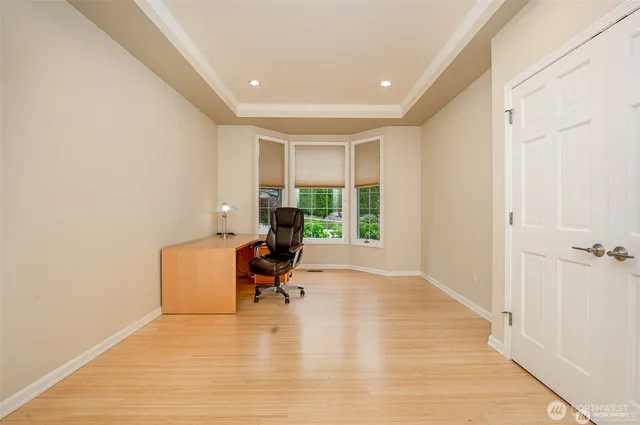 a view of a room that has a large window and a bed