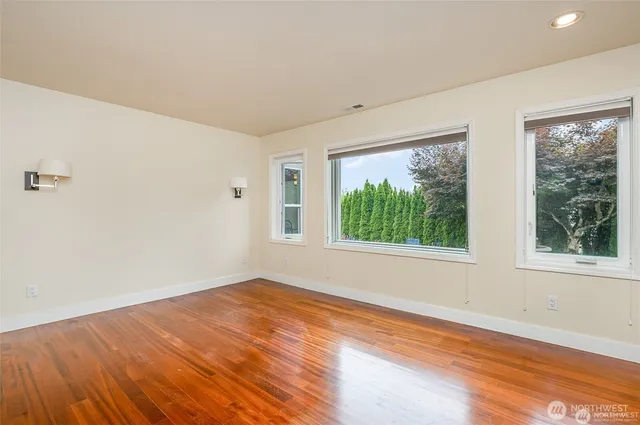 a bedroom with a bed and a lamp on dresser