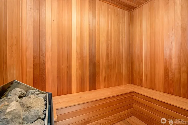 a bathroom with a granite countertop sink a toilet and a mirror