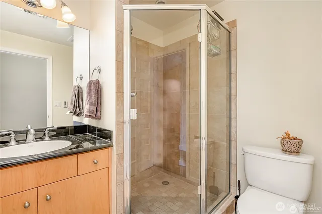 a utility room with stainless steel appliances granite countertop a sink and cabinets