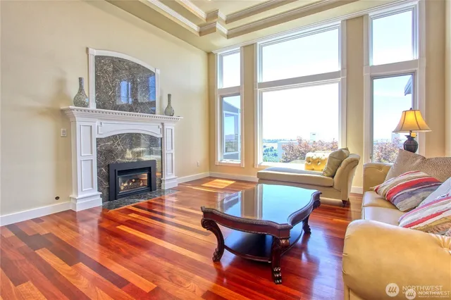 a living room with furniture a fireplace and next to a window