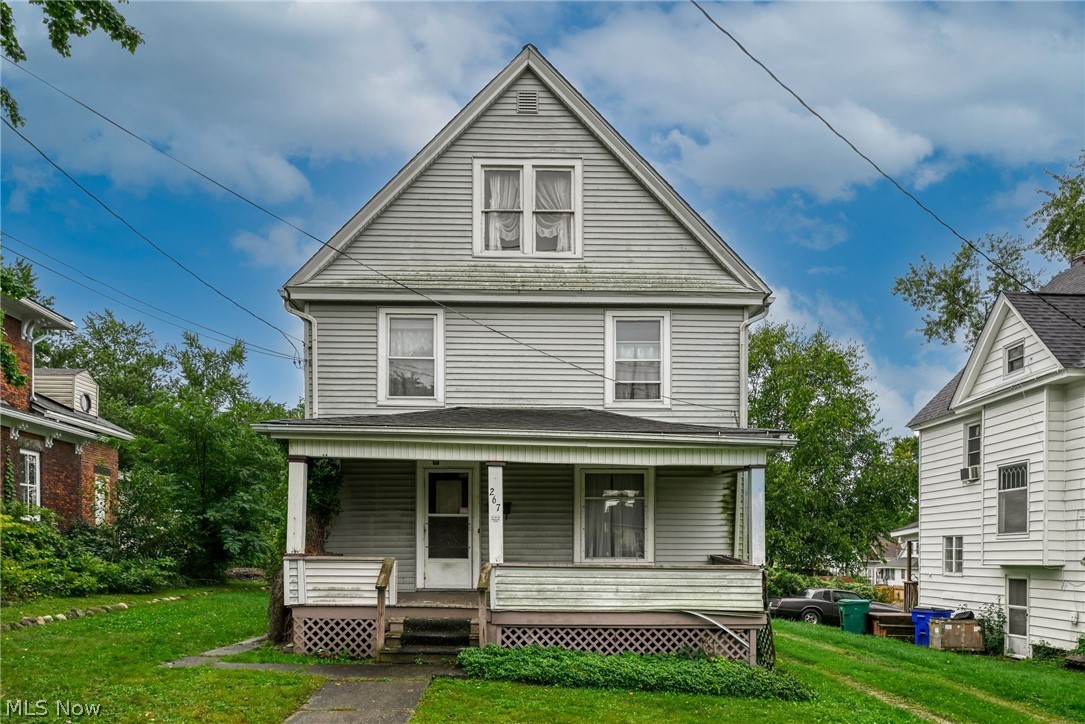 267 West Riddle Avenue Ravenna, OH 44266 - Photo 1 of 47 Gabled roofline, front porch, horizontal siding, multiple windows, and a paved walkway