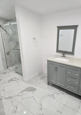 a bathroom with a sink a toilet and mirror