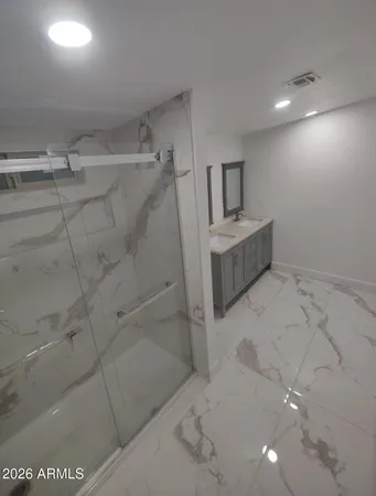 a bathroom with a bathtub and shower