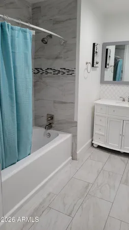 a bathroom with a bathtub and a shower