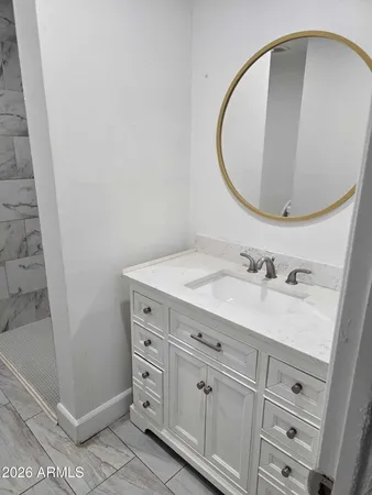a bathroom with a sink and a mirror