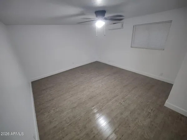 an empty room with a empty space and a ceiling fan