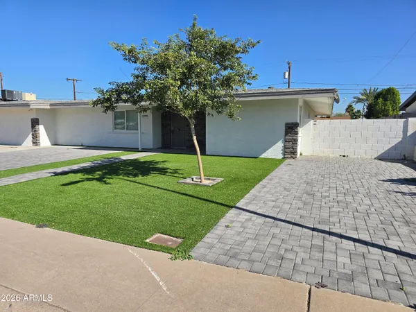 a front view of a house with a yard and a garage