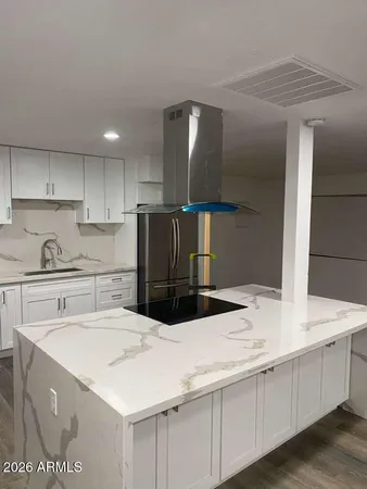 a kitchen with stainless steel appliances kitchen island sink refrigerator and stove