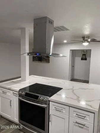 a stove top oven sitting inside of a kitchen