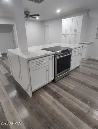 a kitchen with stainless steel appliances granite countertop a stove a sink and a refrigerator