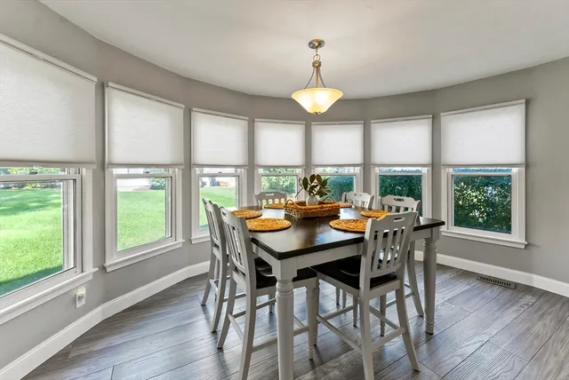 a view of a dining room with furniture and window
