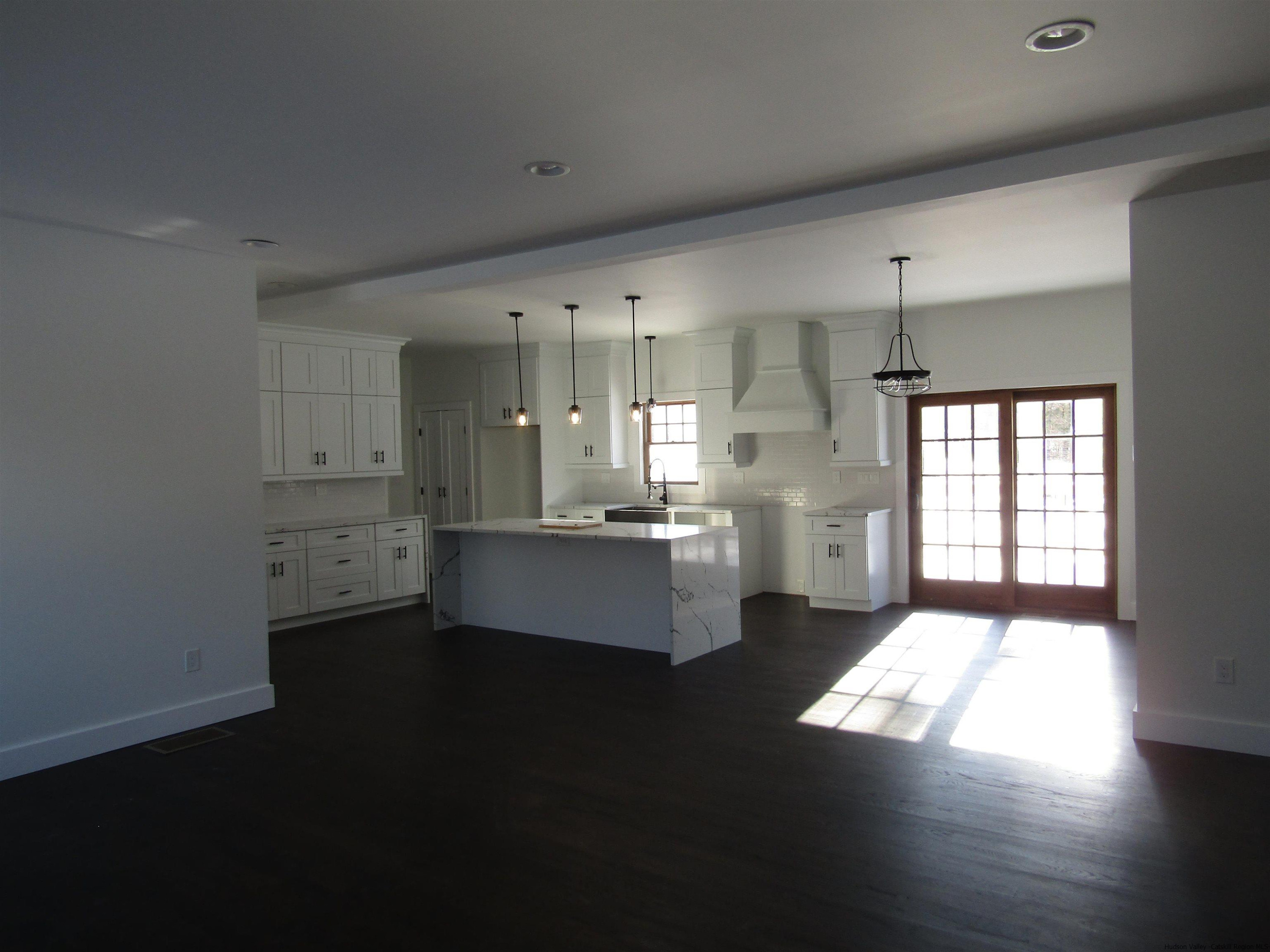 51 Duck Pond Road Stone Ridge, NY 12484 - Photo 13 of 31 a large kitchen with kitchen island white cabinets and stainless steel appliances