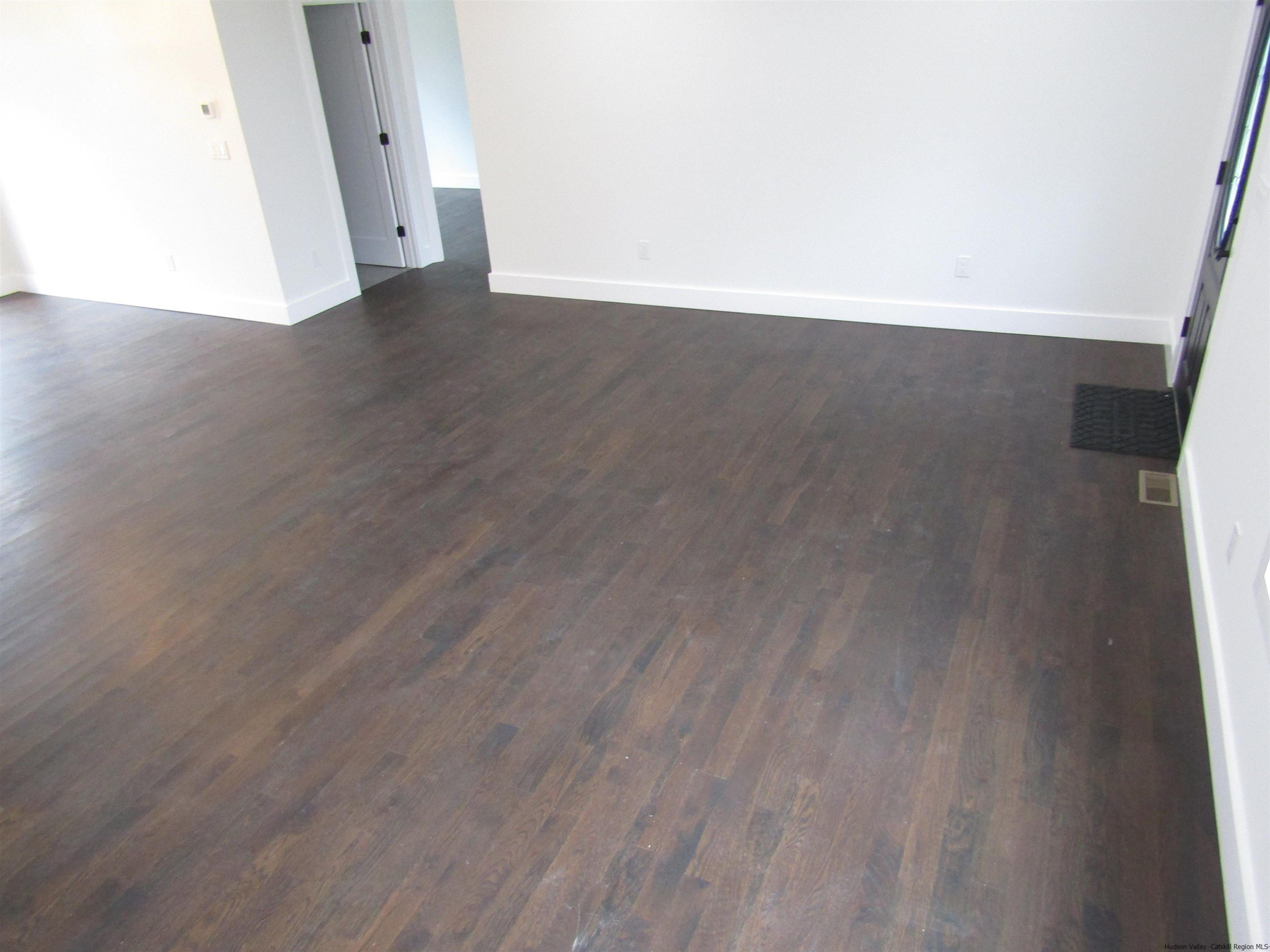 51 Duck Pond Road Stone Ridge, NY 12484 - Photo 16 of 31 a view of an empty room with wooden floor and a window