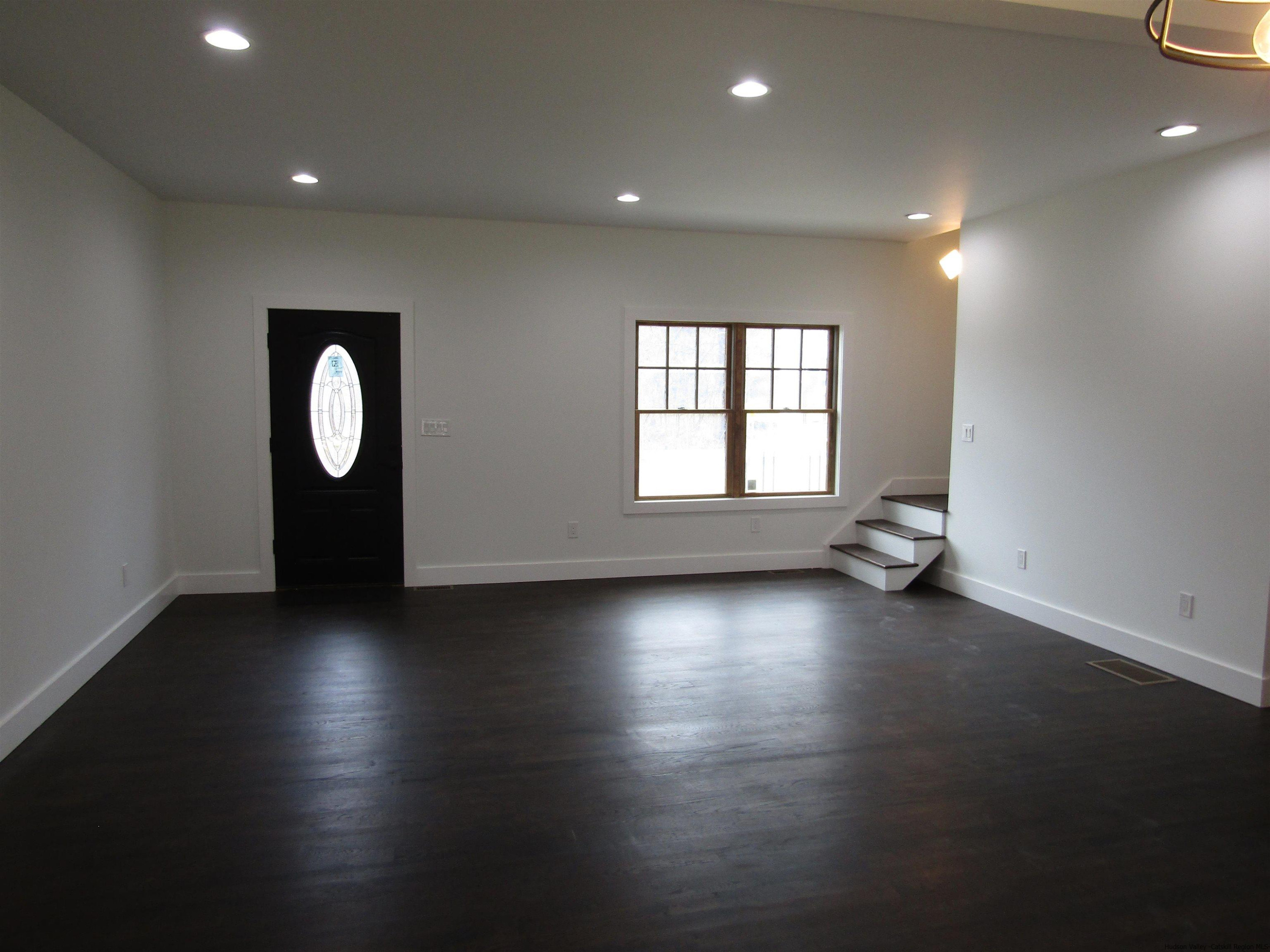 51 Duck Pond Road Stone Ridge, NY 12484 - Photo 17 of 31 an empty room with wooden floor and windows