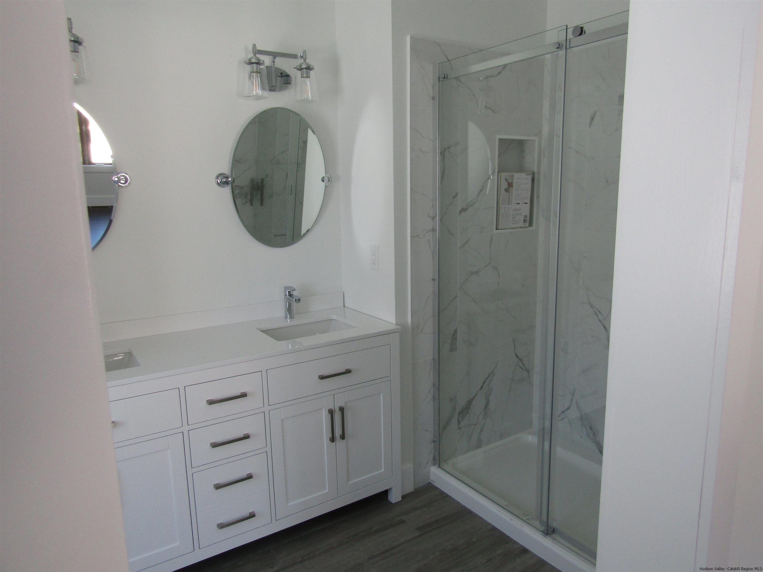 51 Duck Pond Road Stone Ridge, NY 12484 - Photo 20 of 31 a bathroom with a granite countertop sink a mirror and shower