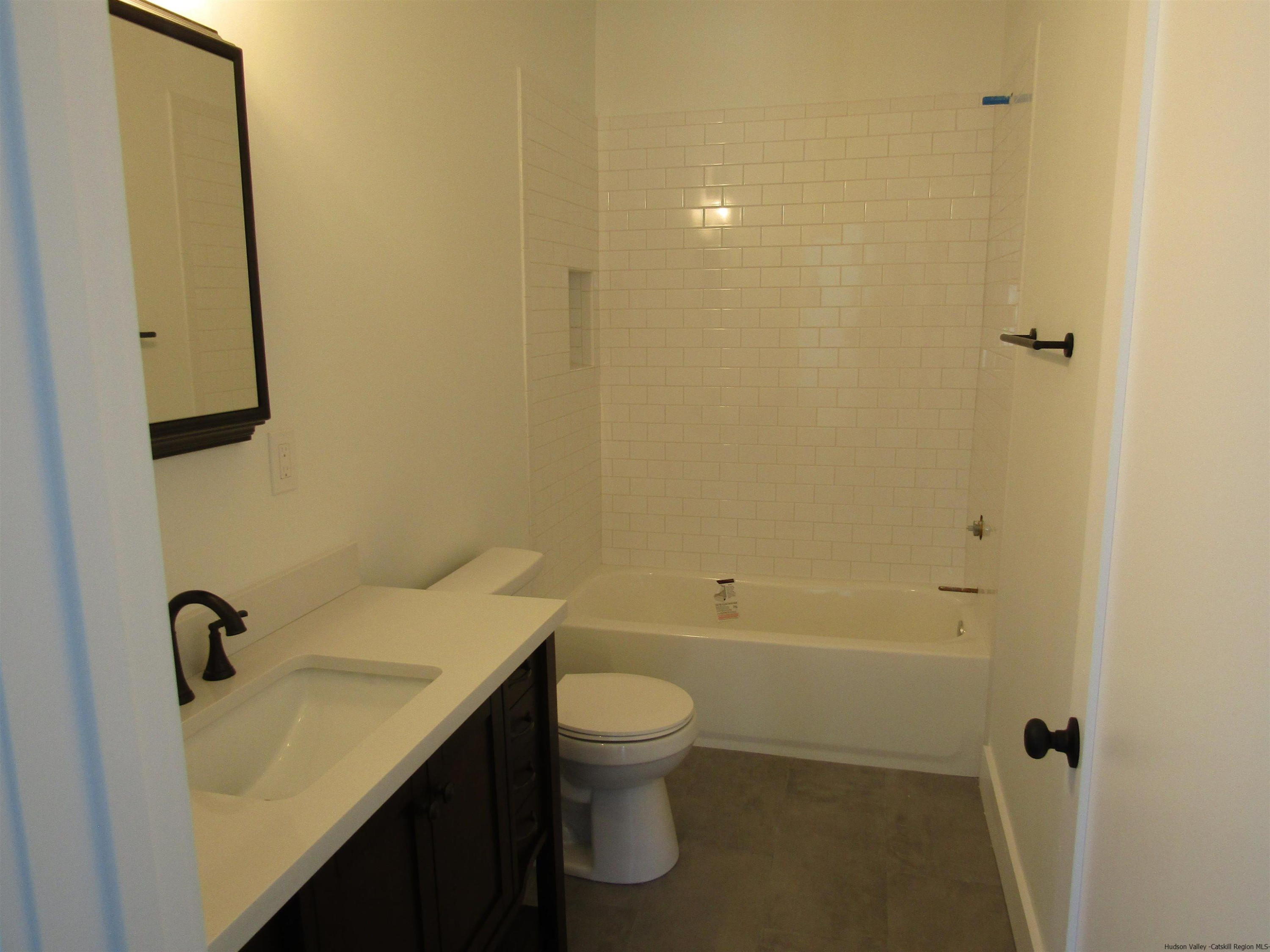 51 Duck Pond Road Stone Ridge, NY 12484 - Photo 24 of 31 a bathroom with a sink a toilet and shower