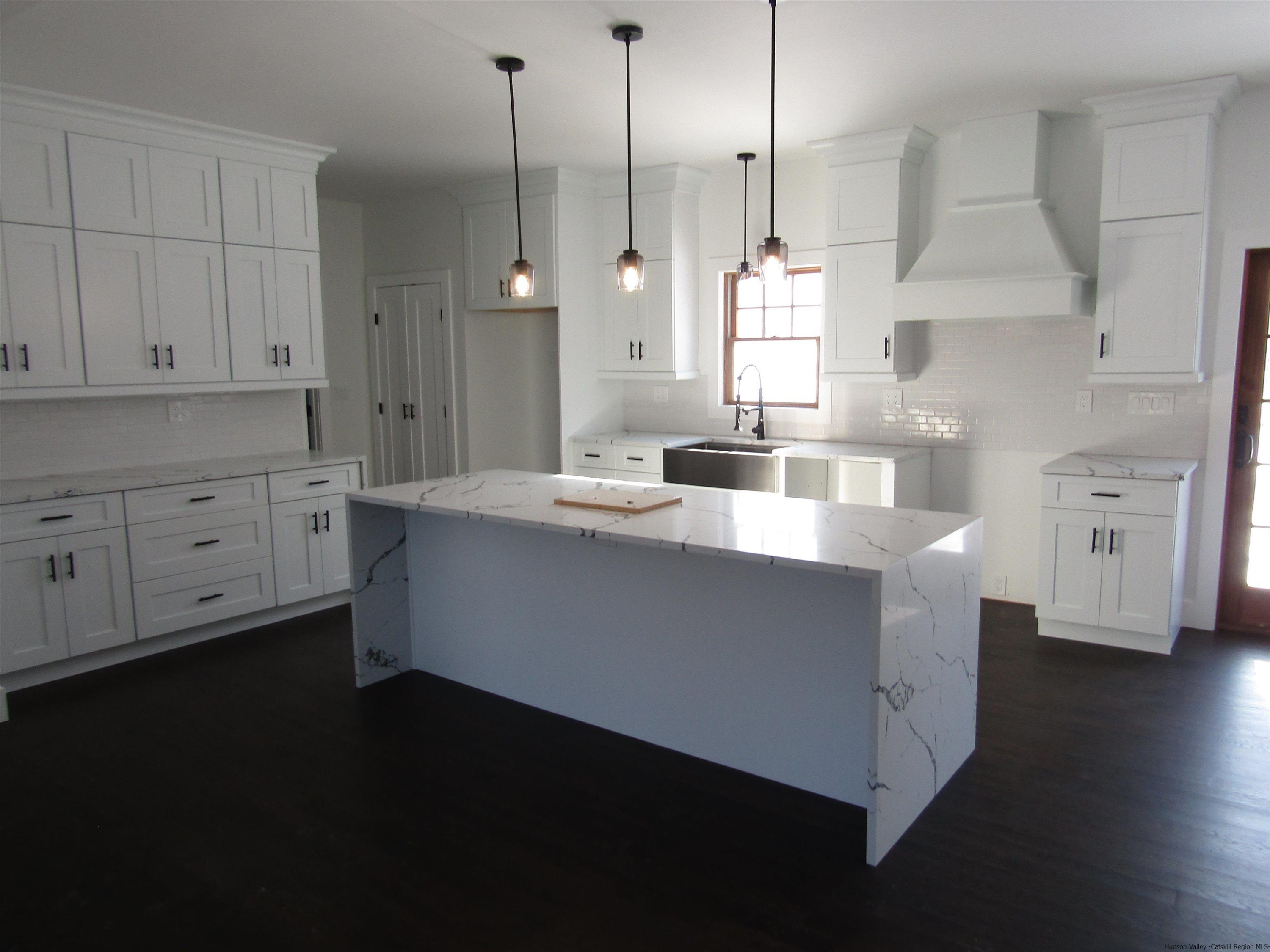 51 Duck Pond Road Stone Ridge, NY 12484 - Photo 10 of 31 a large kitchen with kitchen island white cabinets and stainless steel appliances