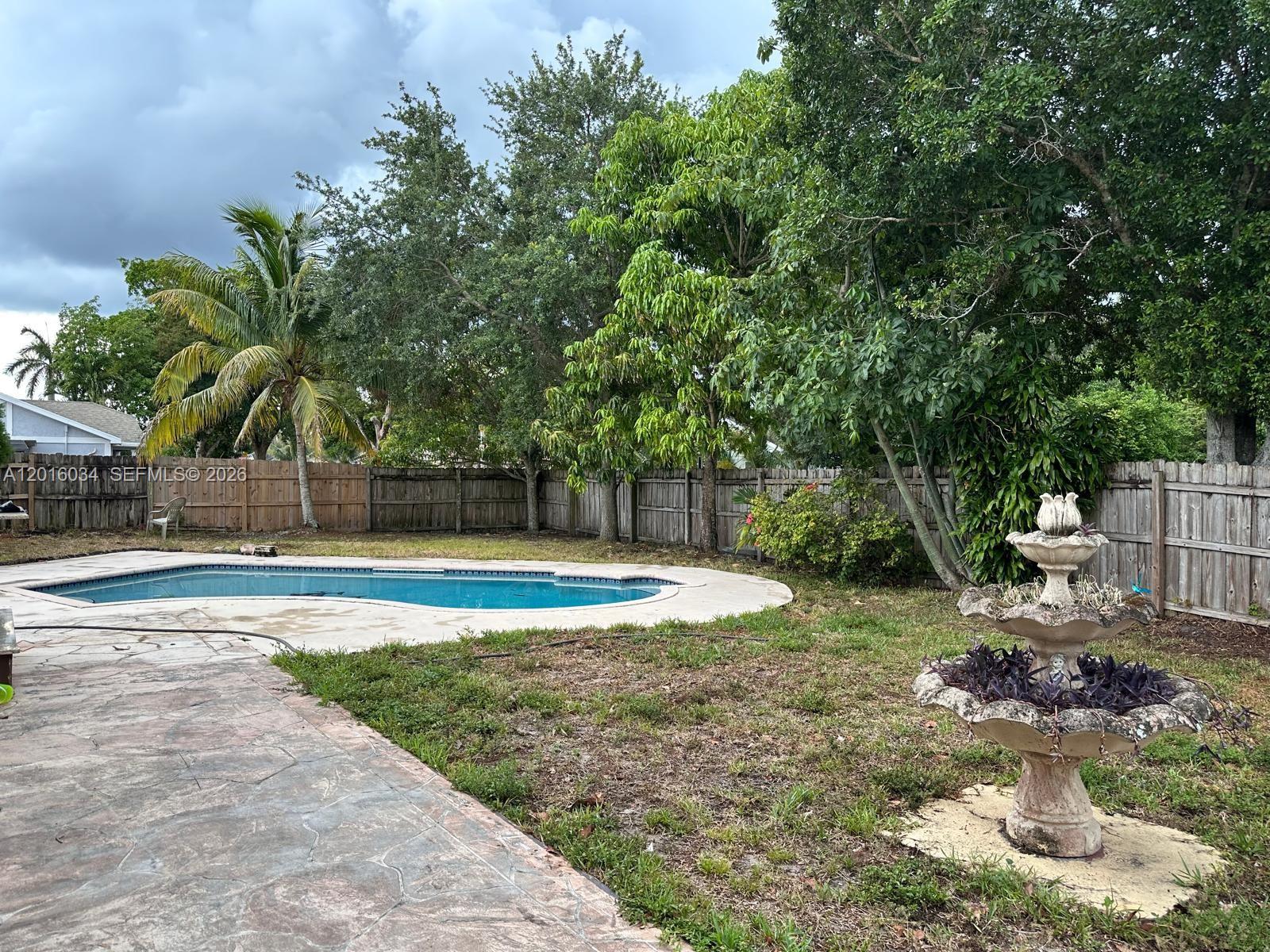 11143 Model Circle East Boca Raton, FL 33428 - Photo 15 of 15 a view of a backyard with swimming pool