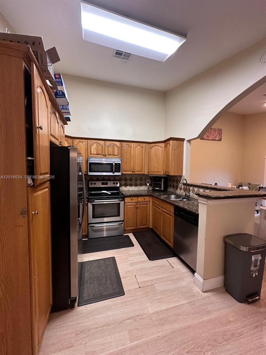 11143 Model Circle East Boca Raton, FL 33428 - Photo 5 of 15 a kitchen with granite countertop a refrigerator and a stove