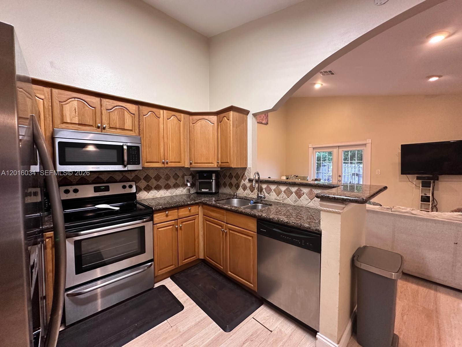 11143 Model Circle East Boca Raton, FL 33428 - Photo 6 of 15 a kitchen with stainless steel appliances a stove sink microwave and cabinets