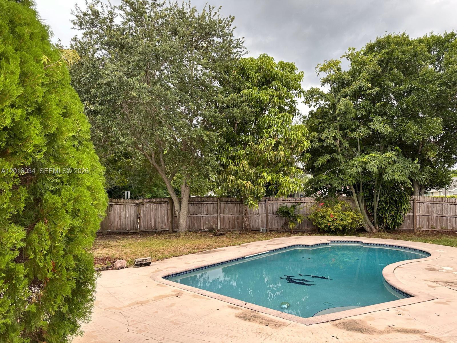 11143 Model Circle East Boca Raton, FL 33428 - Photo 8 of 15 a view of a swimming pool with a patio