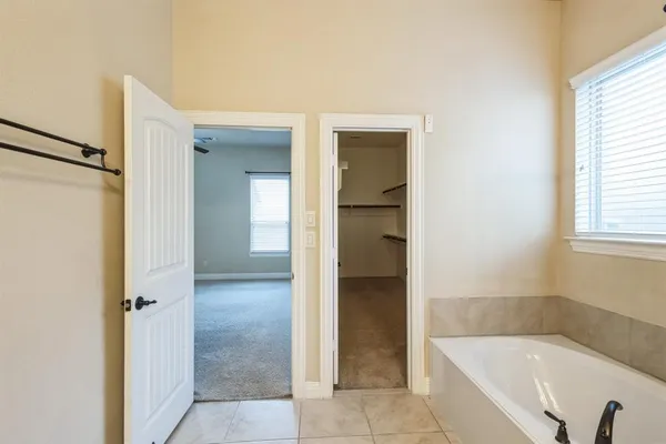 a bathroom with a bathtub and shower