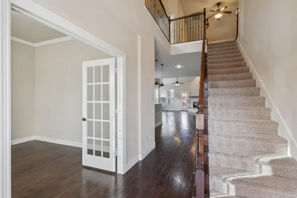a view of entryway and hall with wooden floor