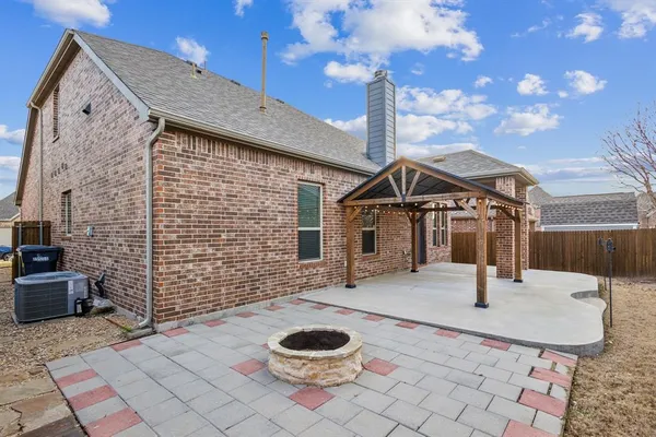a backyard of a house with barbeque oven