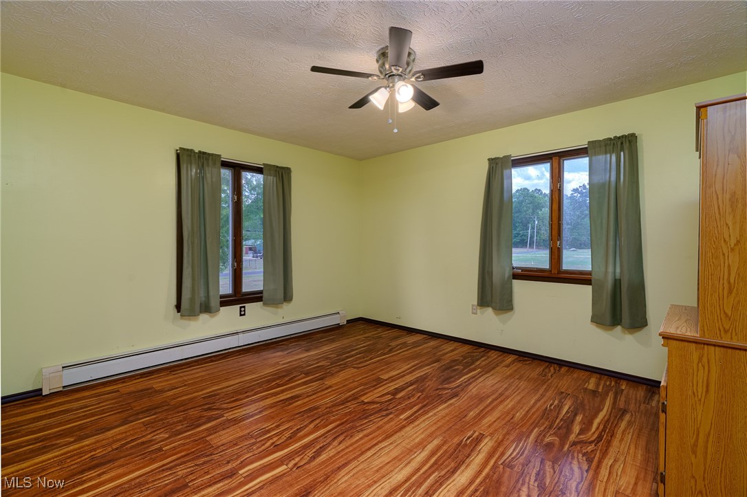 6747 Giddings Road Rootstown, OH 44272 - Photo 12 of 39 Master bedroom featuring a ceiling fan and two windows