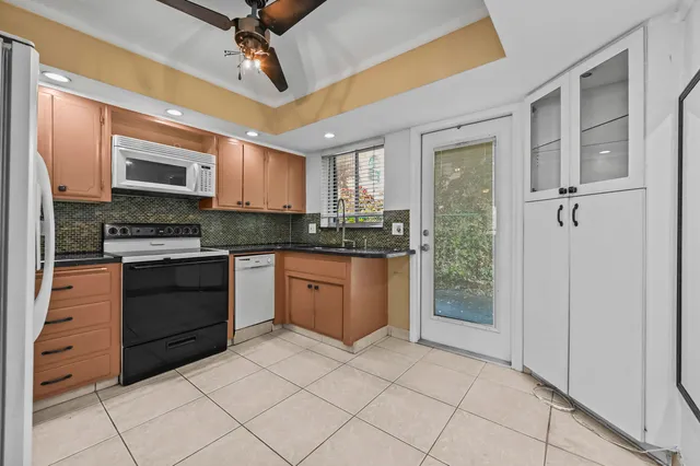 a kitchen with stainless steel appliances granite countertop a stove cabinets and a sink