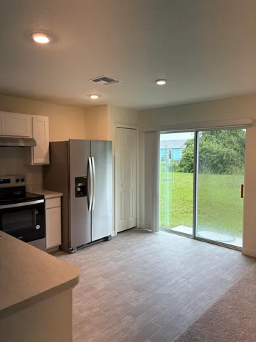 a view of an empty room with a kitchen stove back oven