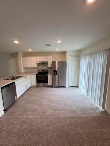a large kitchen with a large window