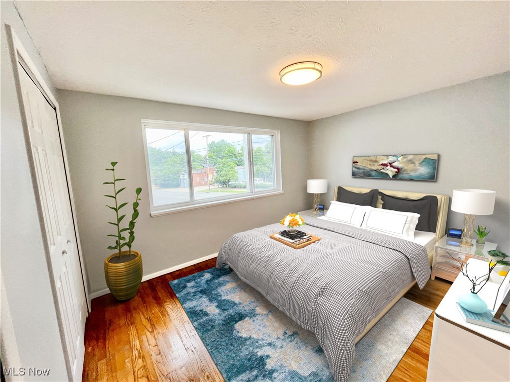 2868 Noble Road, Unit 16 Cleveland, OH 44121 - Photo 6 of 6 Bedroom with wood finished floors, a closet, and a textured ceiling