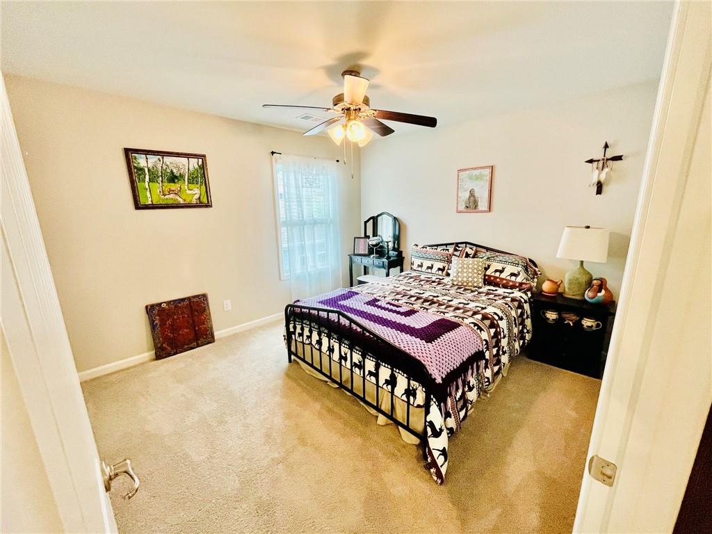 3015 Winding Ridge Waleska, GA 30183 - Photo 30 of 40 a bedroom with a bed and a table with rug