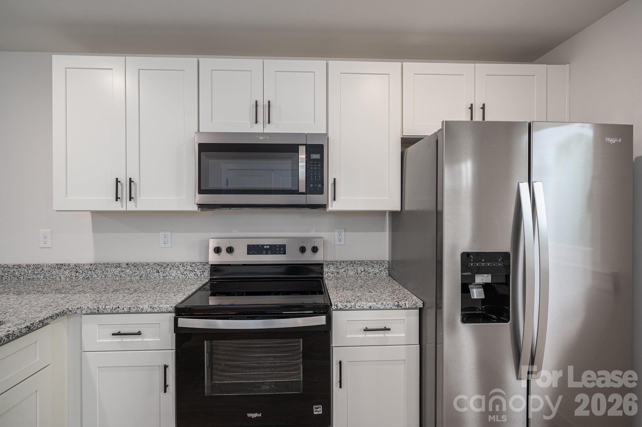 1331 33rd Street Southeast Conover, NC 28613 - Photo 14 of 15 a kitchen with stainless steel appliances granite countertop a refrigerator stove and microwave