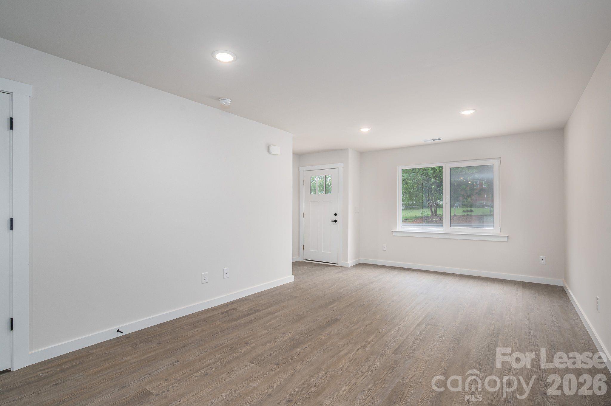 1331 33rd Street Southeast Conover, NC 28613 - Photo 15 of 15 a view of an empty room with wooden floor and a window
