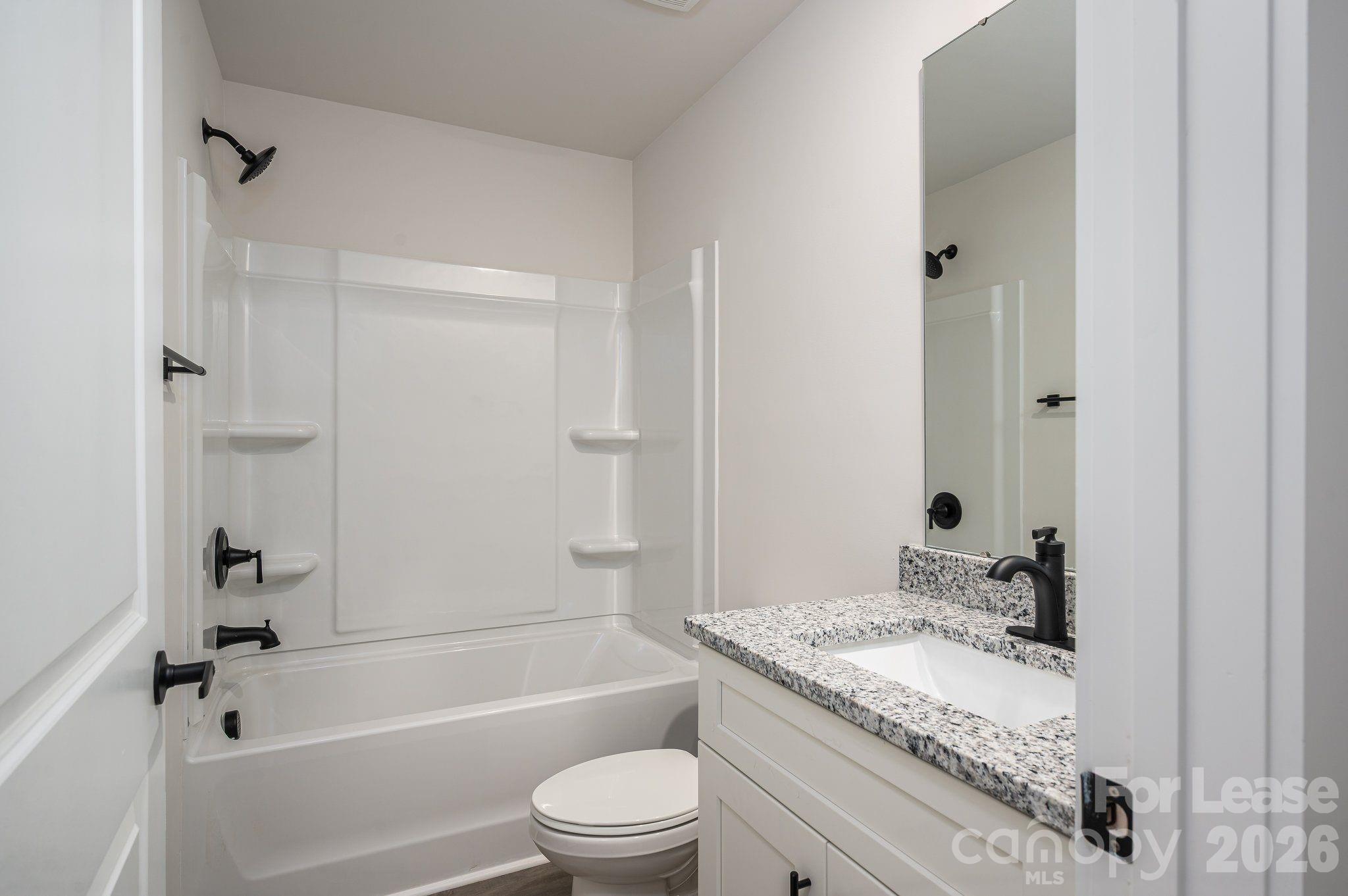 1331 33rd Street Southeast Conover, NC 28613 - Photo 9 of 15 a bathroom with a granite countertop sink a toilet and shower