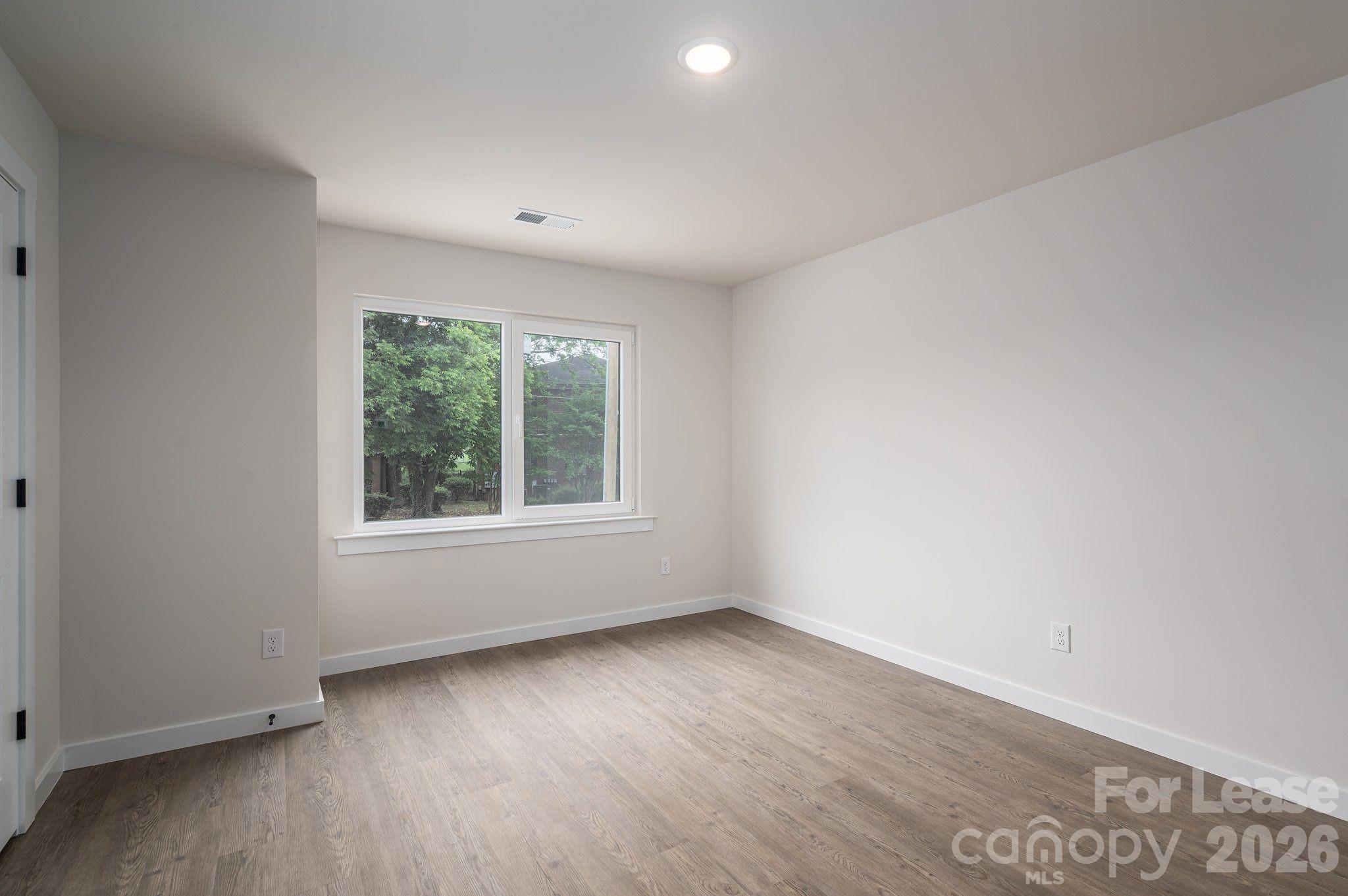 1331 33rd Street Southeast Conover, NC 28613 - Photo 10 of 15 an empty room with wooden floor and windows