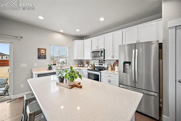 a living room with furniture and kitchen view