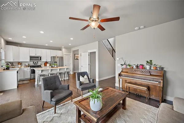 a living room with furniture a chandelier and a window