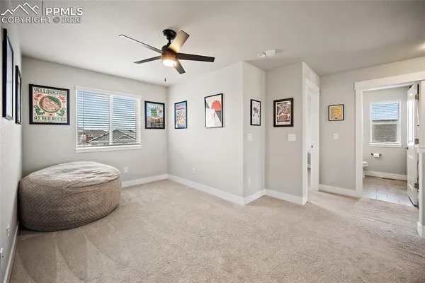 a view of a livingroom with a ceiling fan and window
