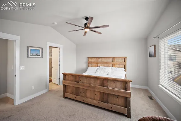 a bed room with a bed and a chair