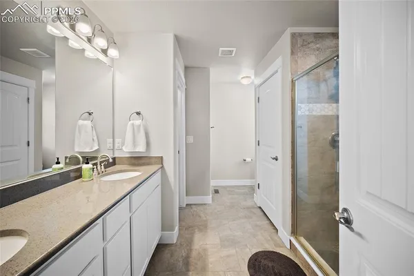a bathroom with a sink double vanity and a mirror