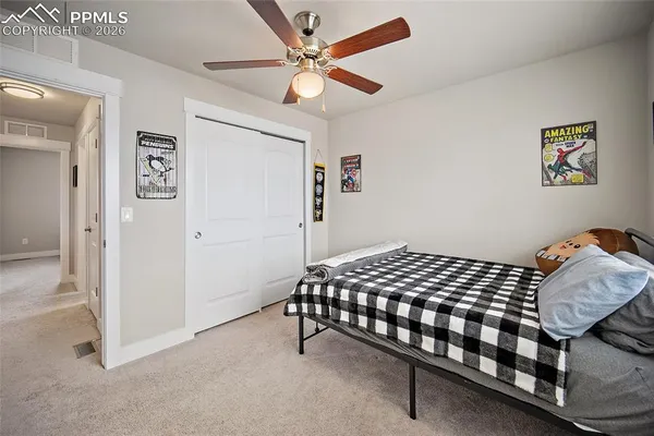 a bathroom with a granite countertop sink mirror vanity and toilet