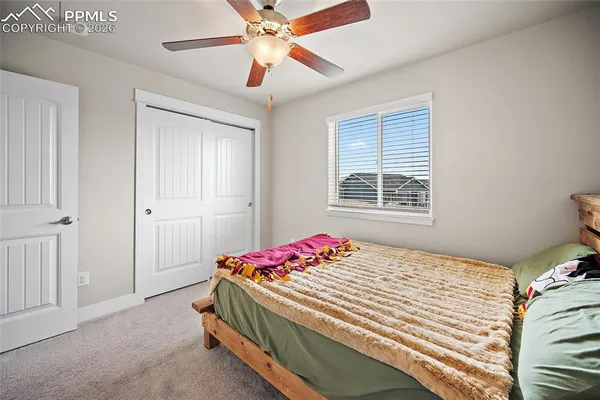 a view of a hallway with a livingroom and a bedroom with furniture