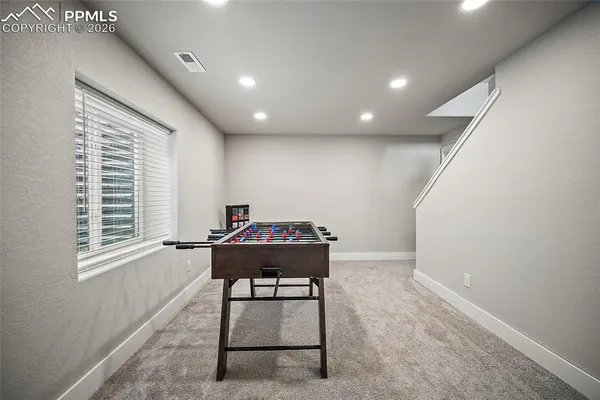 a bathroom with a toilet sink vanity and mirror