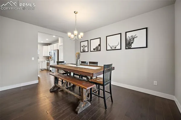 a room with a table chairs and wooden floor