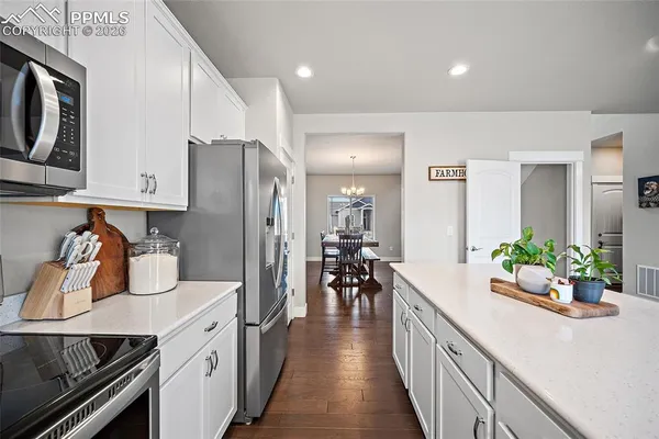 a kitchen with stove and cabinets